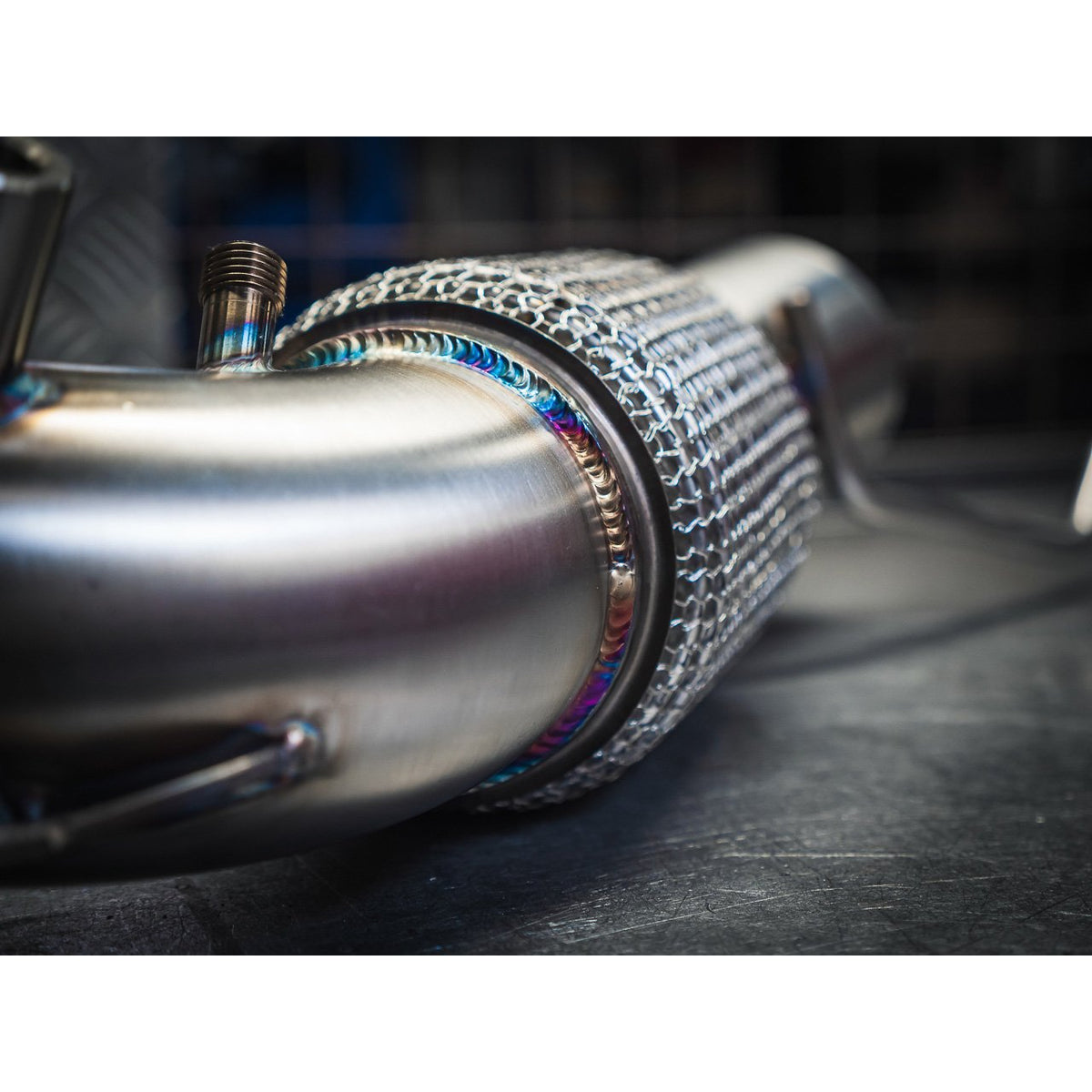 Cobra Sport front downpipe with sports cat for BMW 128ti F40, featuring sleek metal construction and standard fitment.