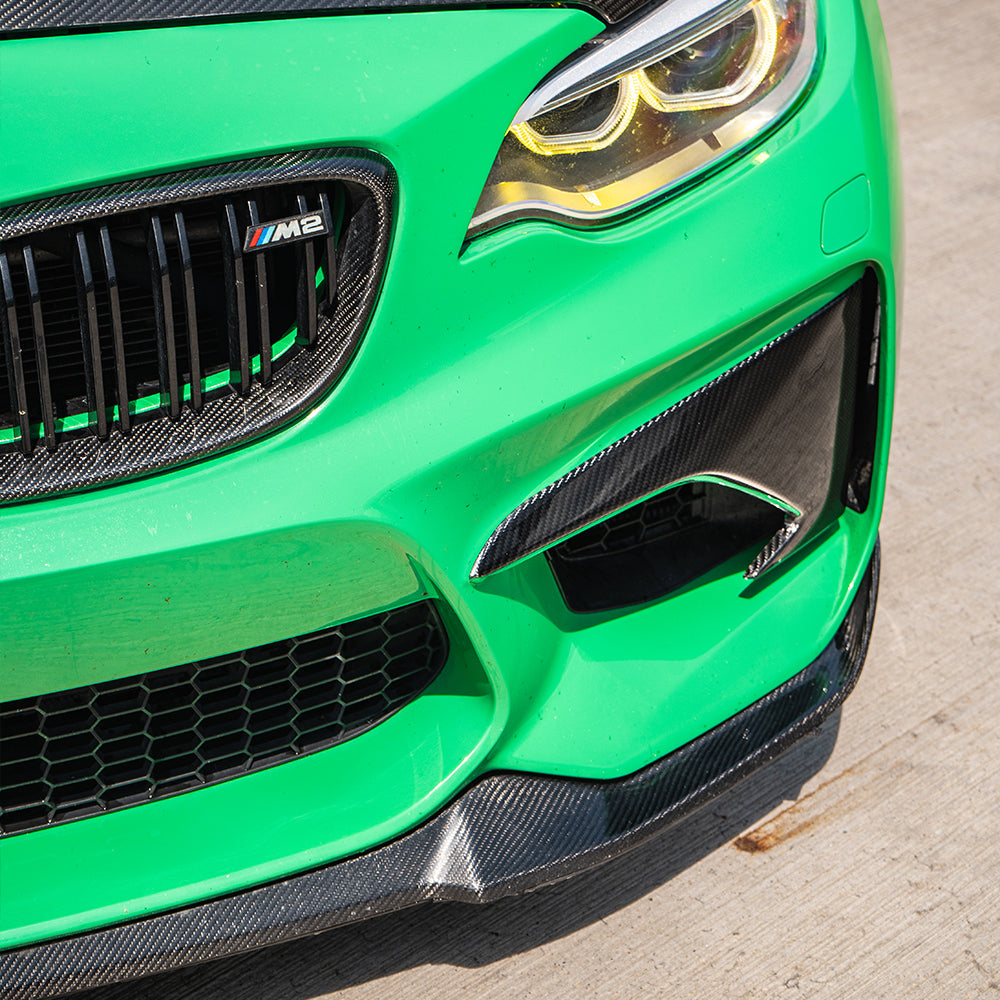 BMW M2 F87 N55 carbon fiber front bumper corners by CT Carbon showing sleek, lightweight carbon fiber accents on the vehicle's front end.