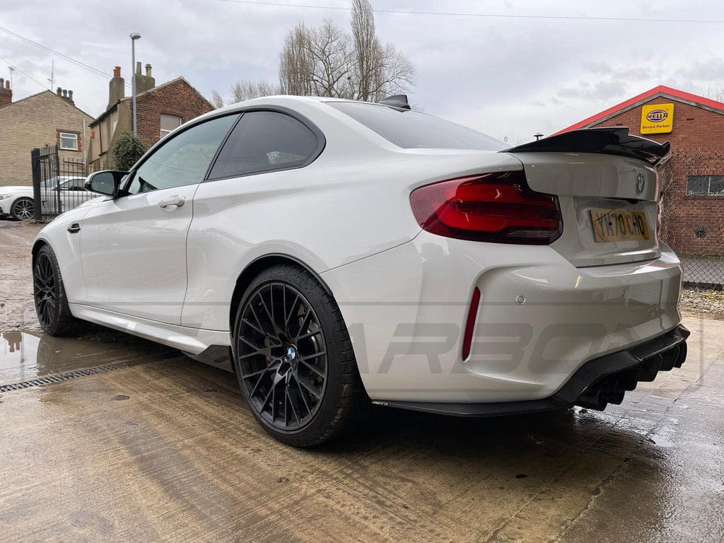 BMW M2 F87 carbon fiber diffuser by CT Carbon, V3 style, showcasing sleek aerodynamic design and high-quality carbon fiber finish.