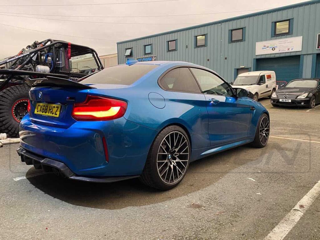 BMW M2 F87 carbon fiber diffuser by CT Carbon, V3 style, showcasing sleek aerodynamic design and high-quality craftsmanship.