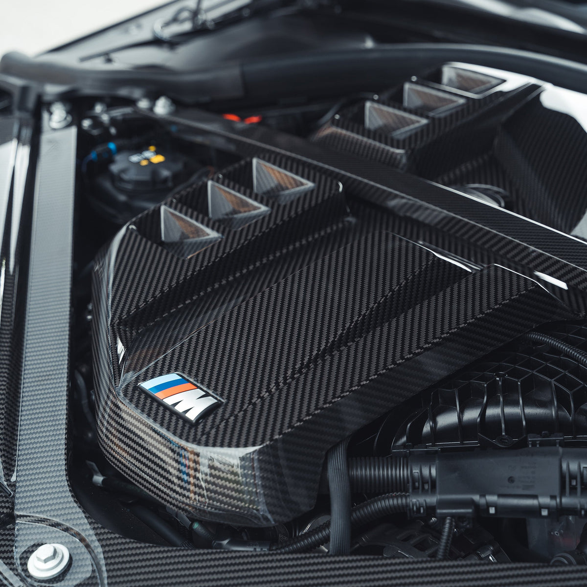 BMW M2 M3 M4 G87 G80 G81 G82 G83 Carbon Fibre Engine Dress Up Kit by CT Carbon, showing sleek carbon fiber accents on engine components.