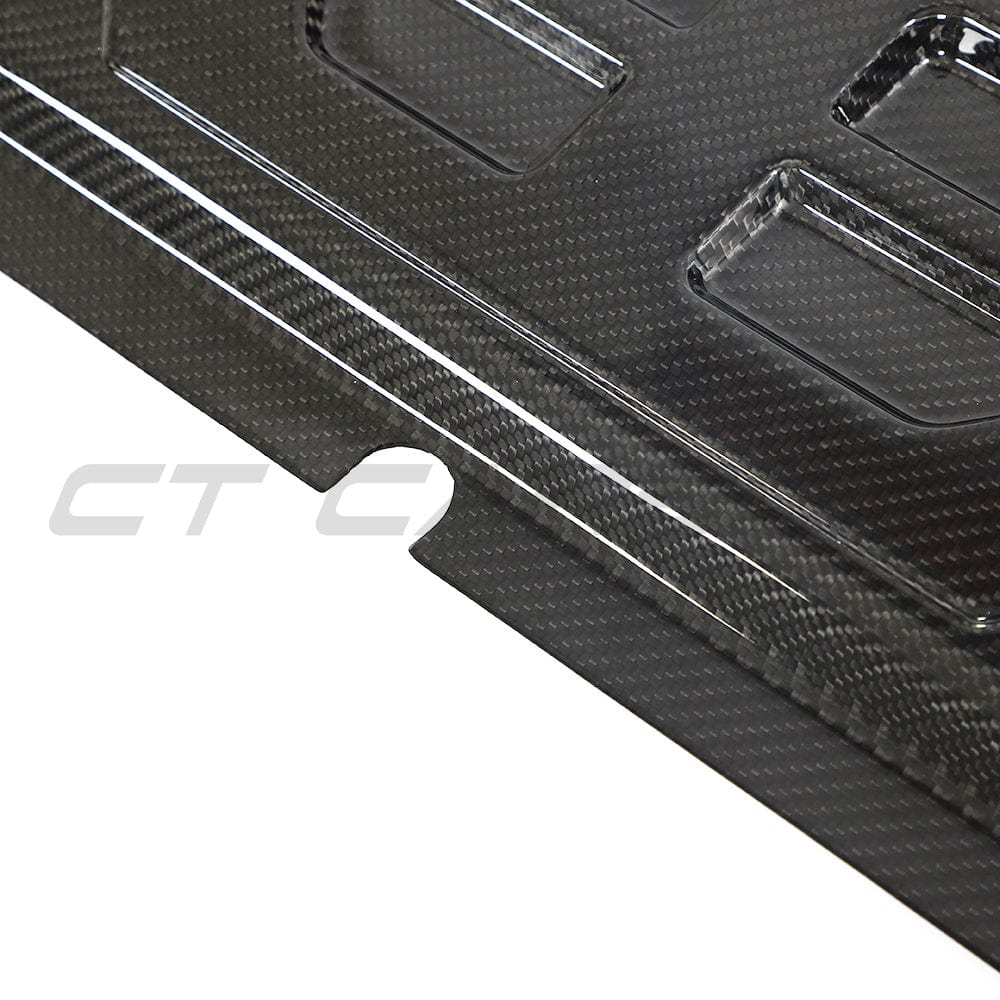 BMW M2, M3, M4 G87/G80/G81/G82/G83 carbon fiber slam panel cover by CT Carbon, close-up of sleek, lightweight automotive accessory.