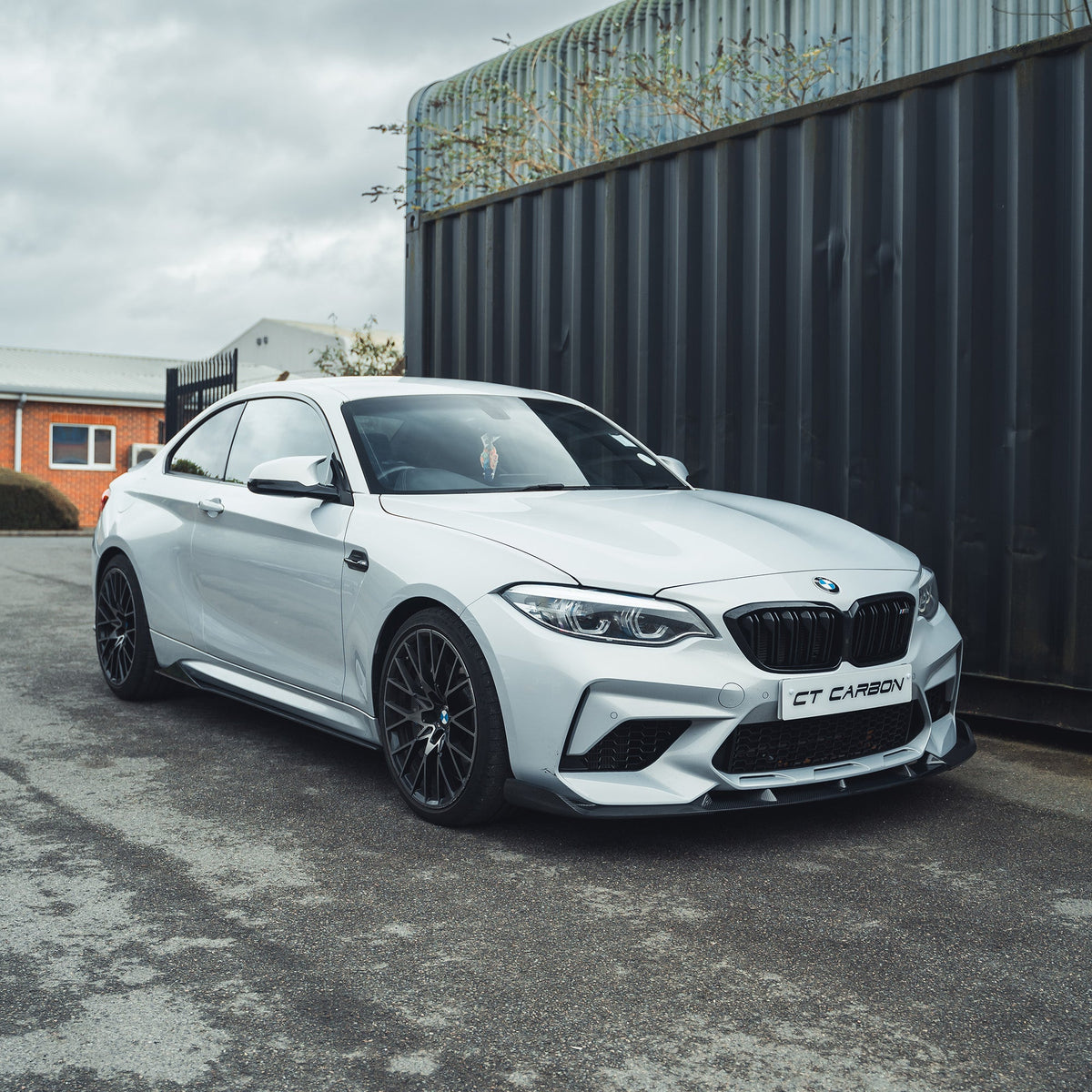BMW M2C F87 carbon fibre splitter V2 by CT Carbon, showing the sleek 3D-style design and aerodynamic details.