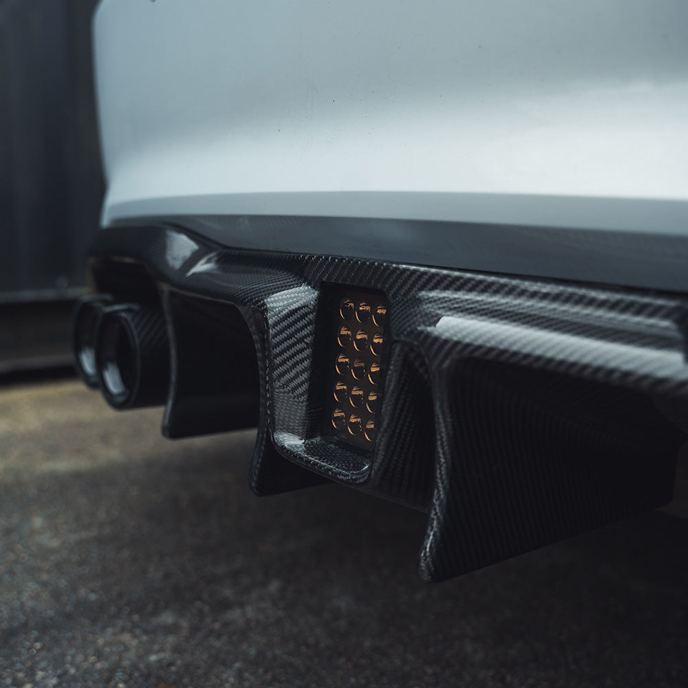 BMW M2 F87 carbon fibre diffuser by CT Carbon, showcasing an aggressive design with V6 styling and textured carbon finish.