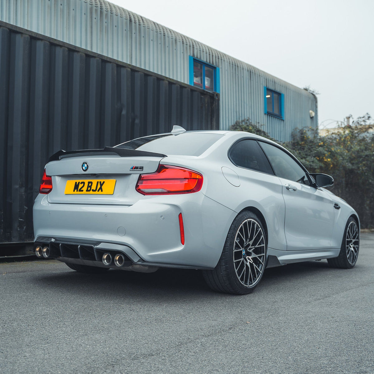 BMW M2 F87 carbon fibre side skirts by CT Carbon, V1 style, showcasing sleek, lightweight aerodynamic design from the side.
