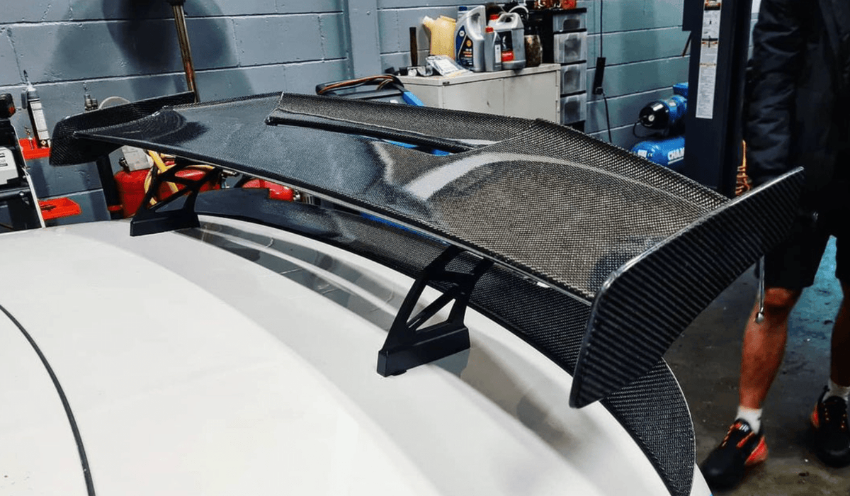 BMW M2 M3 M4 carbon fibre wing spoiler by CT Carbon, V2 style, featuring sleek carbon fiber design and aerodynamic shape.
