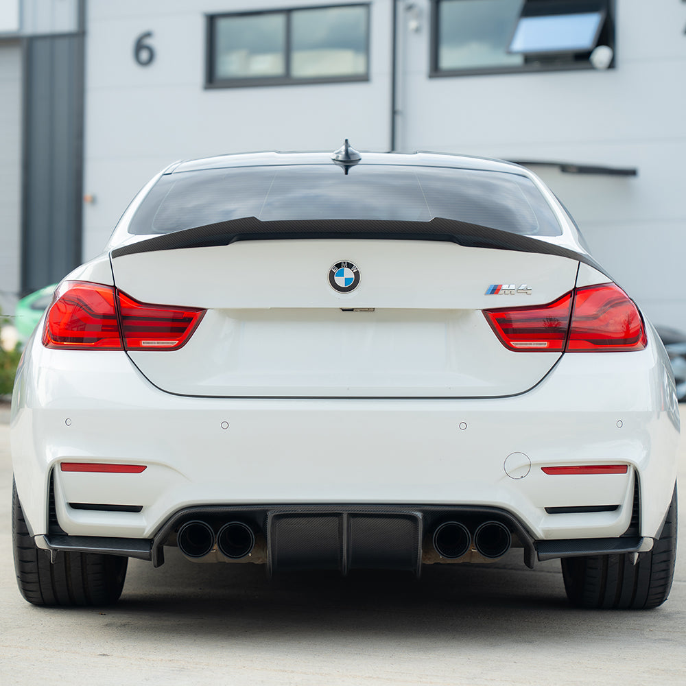 BMW M3 M4 F80 F82 F83 carbon fiber diffuser by CT Carbon with black exhaust tips, showcasing a sleek, aerodynamic design.