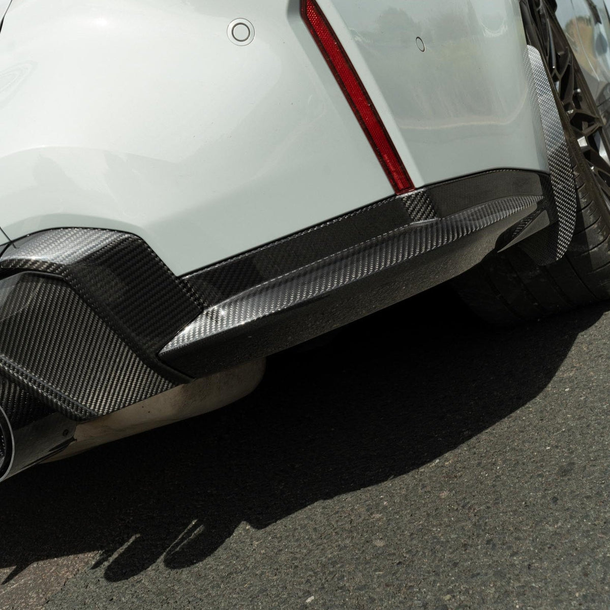 BMW M3 G80 G81 carbon fiber diffuser by CT Design, showcasing sleek black carbon fiber with detailed aerodynamic design.