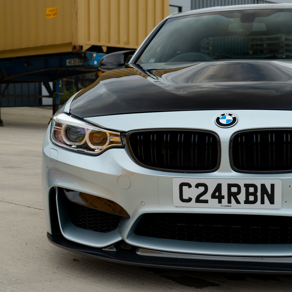BMW M3 M4 F80 F82 F83 carbon fiber upper front canards by CT Carbon, showcasing sleek aerodynamic car accessories.