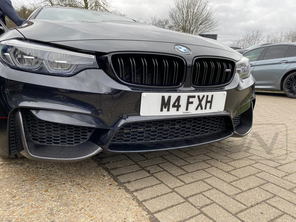 BMW M3 M4 F80 F82 F83 carbon splitter by CT Carbon, showcasing aerodynamic canards and sleek design for enhanced performance.