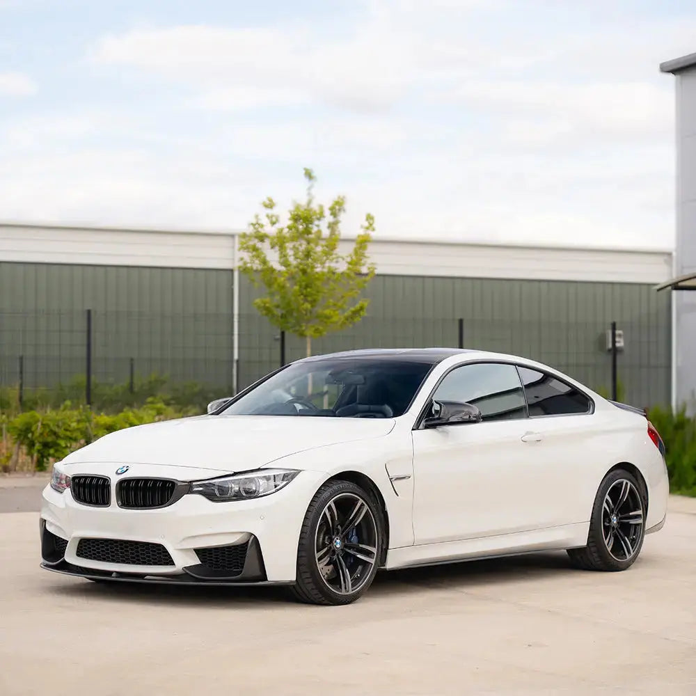 BMW M3 M4 F80 F82 F83 CT Carbon fiber diffuser V2 with sleek design and aerodynamic enhancements, shown on a sporty car.