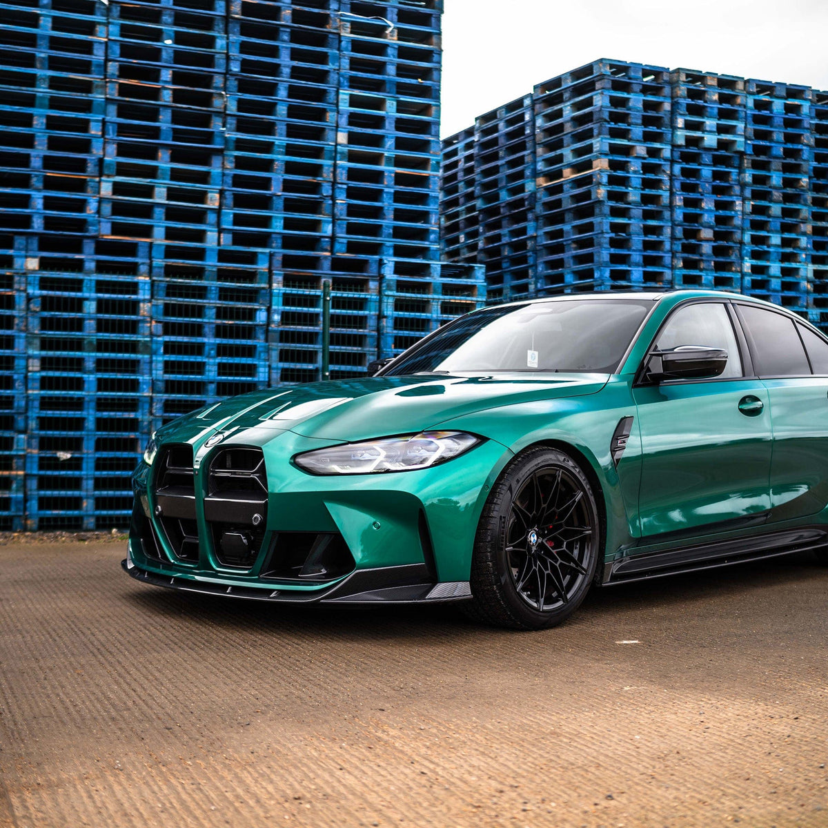 BMW M3 M4 G80 G81 G82 G83 carbon fiber splitter by CT Carbon, showcasing the sleek, aerodynamic design on the front of the car.