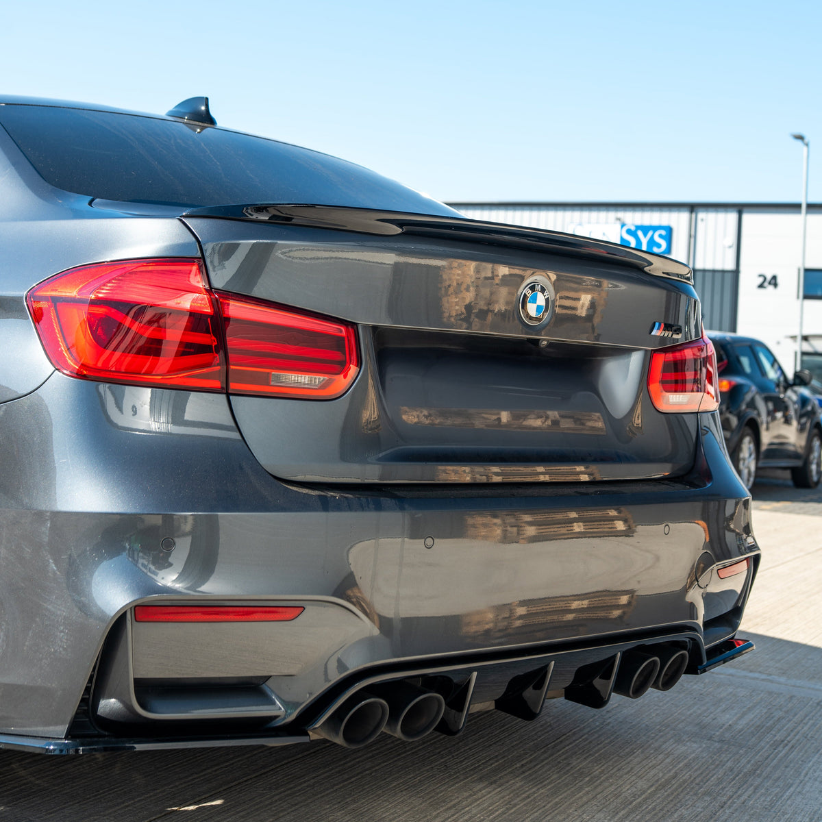 BMW M3 M4 F80 F82 F83 GLOSS BLACK V STYLE diffuser by CT Carbon, shown on the rear of a coupe with sleek black finish.