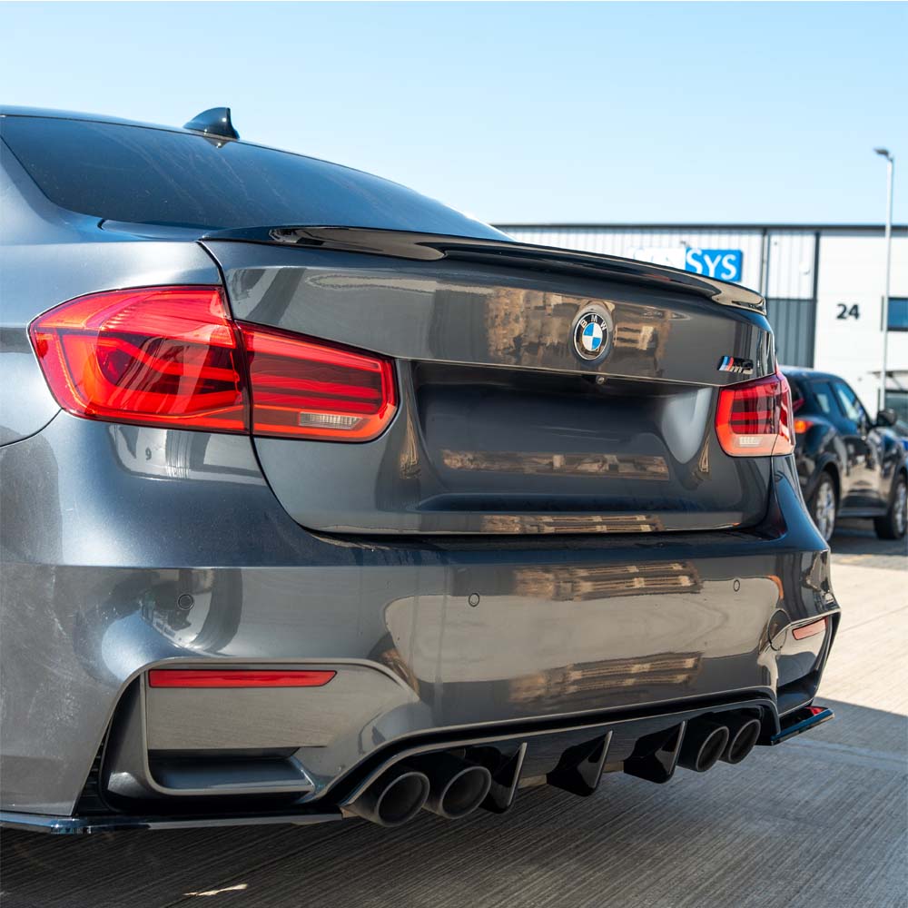 BMW M3 F80 2014-2020 CT Carbon full gloss black kit installed on coupe, showcasing sleek black aerodynamic body parts.