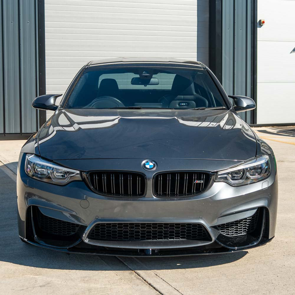 BMW M4 F82 coupe with CT Carbon full gloss black kit, showcasing sleek carbon fiber exterior upgrades and aerodynamic enhancements.