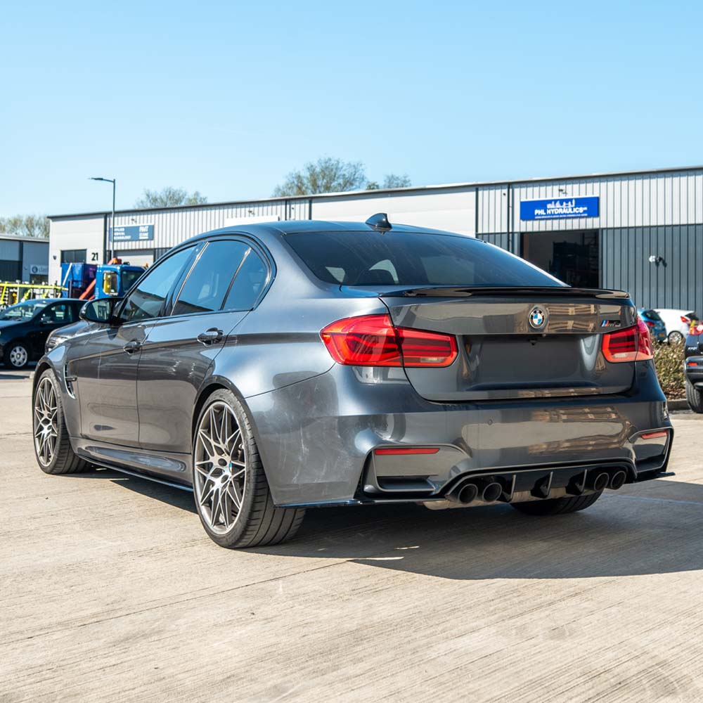 BMW M3 M4 F80 F82 F83 GLOSS BLACK Side Skirts by CT Carbon installed on coupe with sleek, glossy finish.