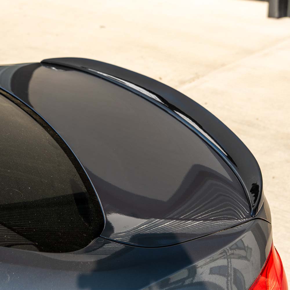 BMW M4 F82 coupe with CT Carbon full gloss black kit, showcasing sleek black exterior components and aerodynamic enhancements.