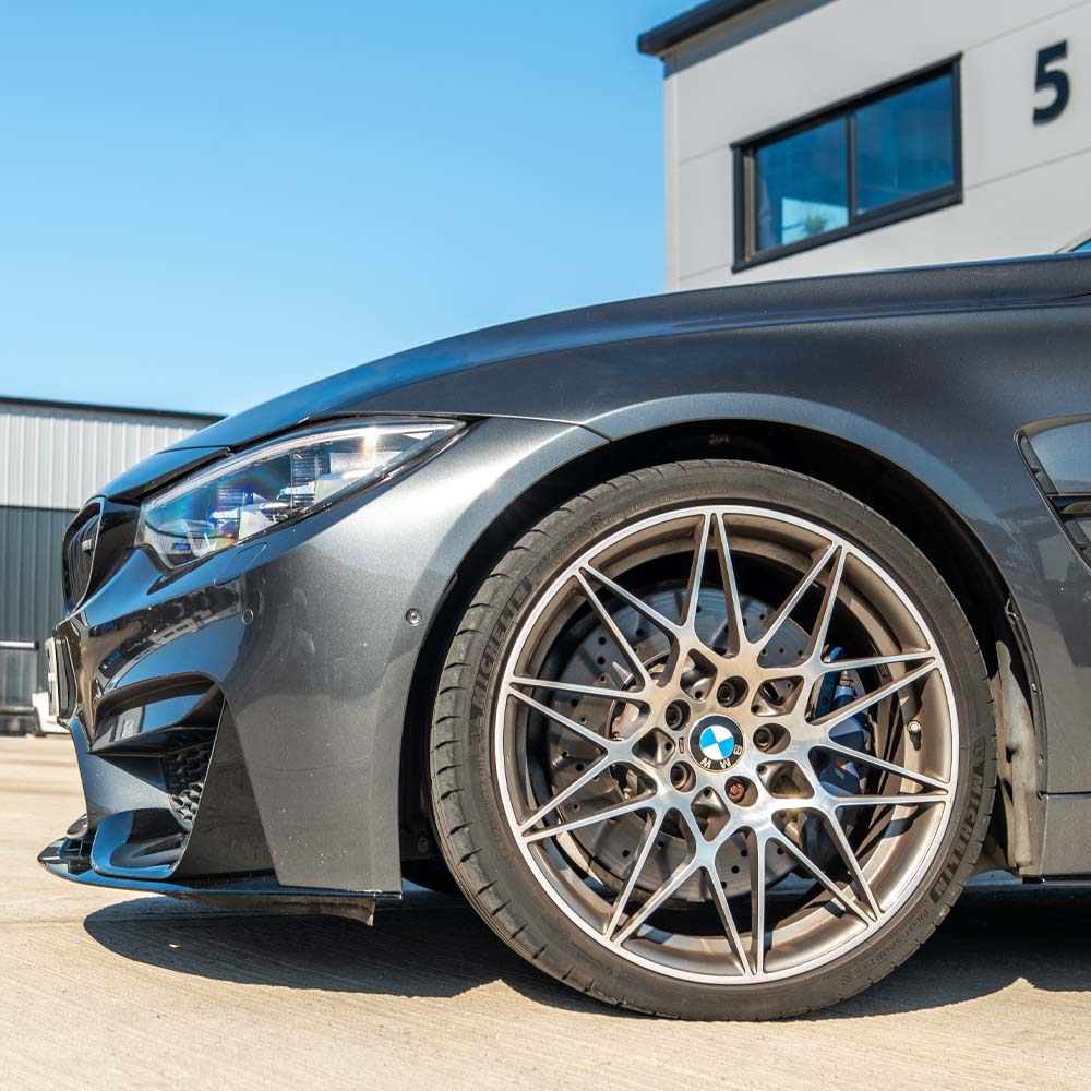 BMW M4 F82 coupe with CT Carbon full gloss black kit, showcasing sleek carbon fiber accents and aerodynamic styling.