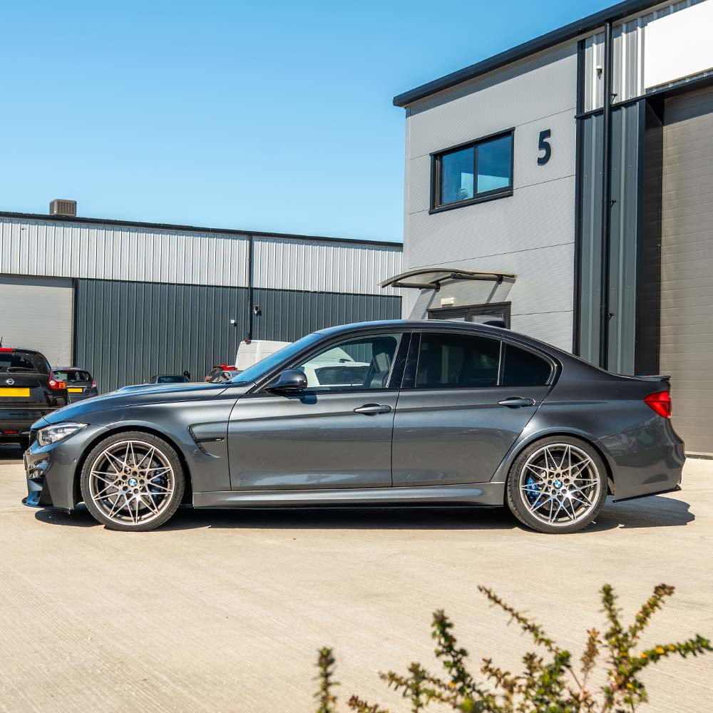 BMW M4 F82 coupe with CT Carbon full gloss black kit installed, showcasing sleek, aerodynamic body parts and high-quality carbon fiber finish.