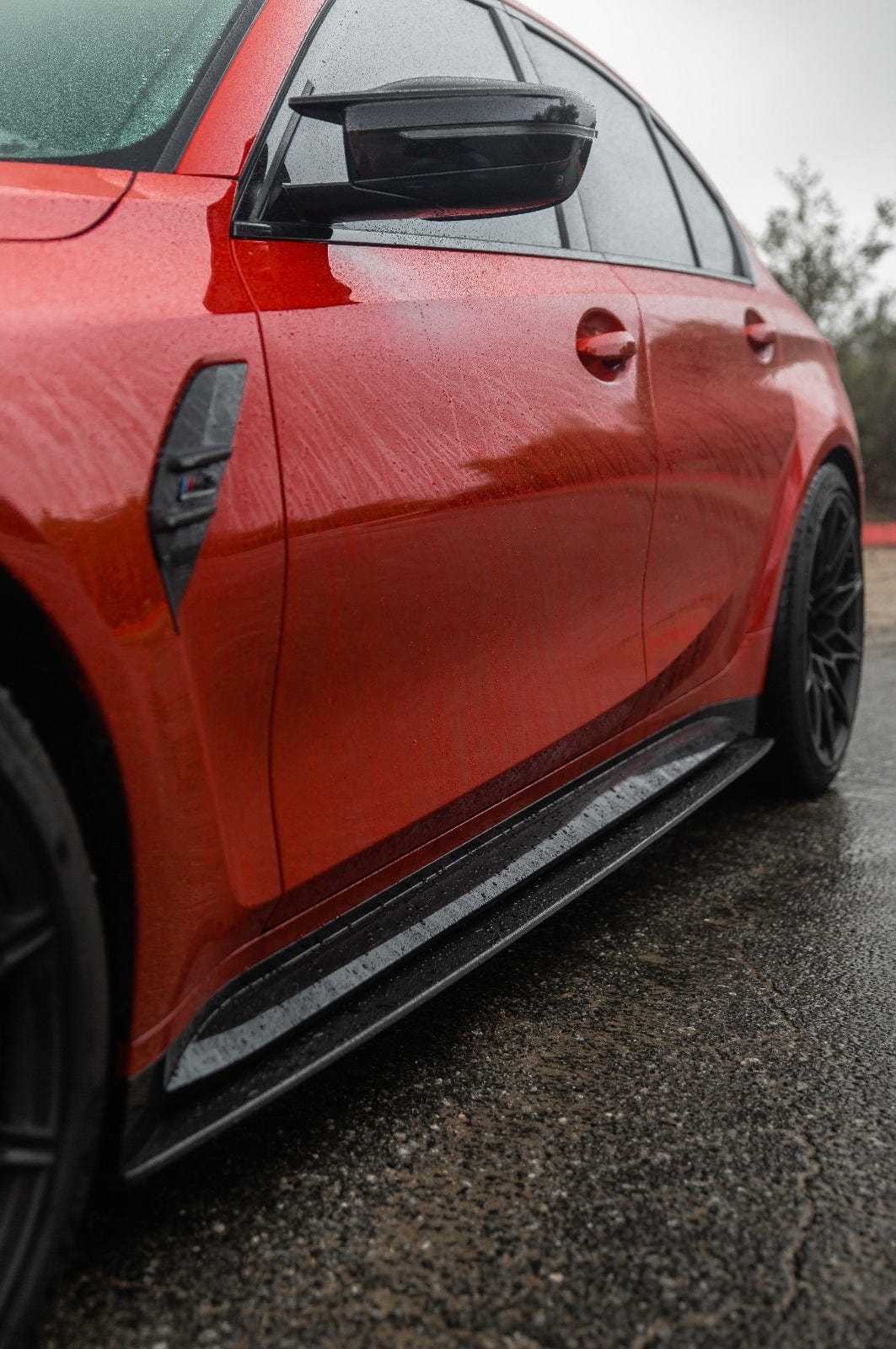 BMW M4 G82 G83 carbon fibre side skirt extensions by CT Carbon, showing sleek, textured design on the vehicle's side.