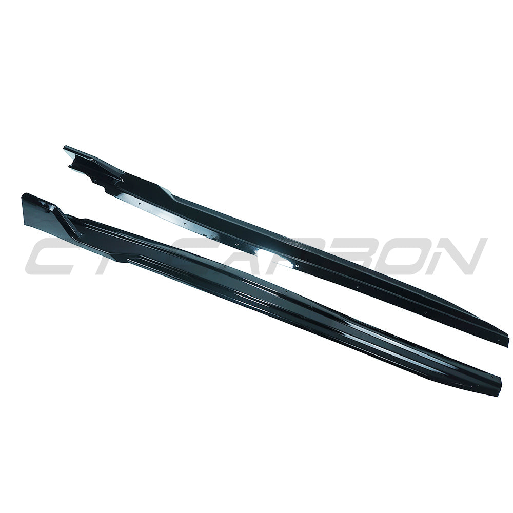 BMW U10 X2 2023 gloss black side skirts by CT Carbon, showing the sleek, aerodynamic design of the car's side profile.