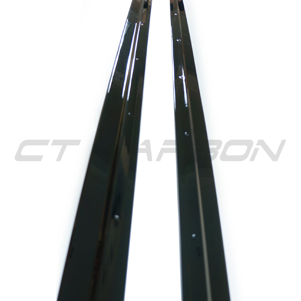 BMW X5 2014-2018 F15 CT Carbon gloss black full-length side skirts installed on vehicle, enhancing sporty exterior appearance.