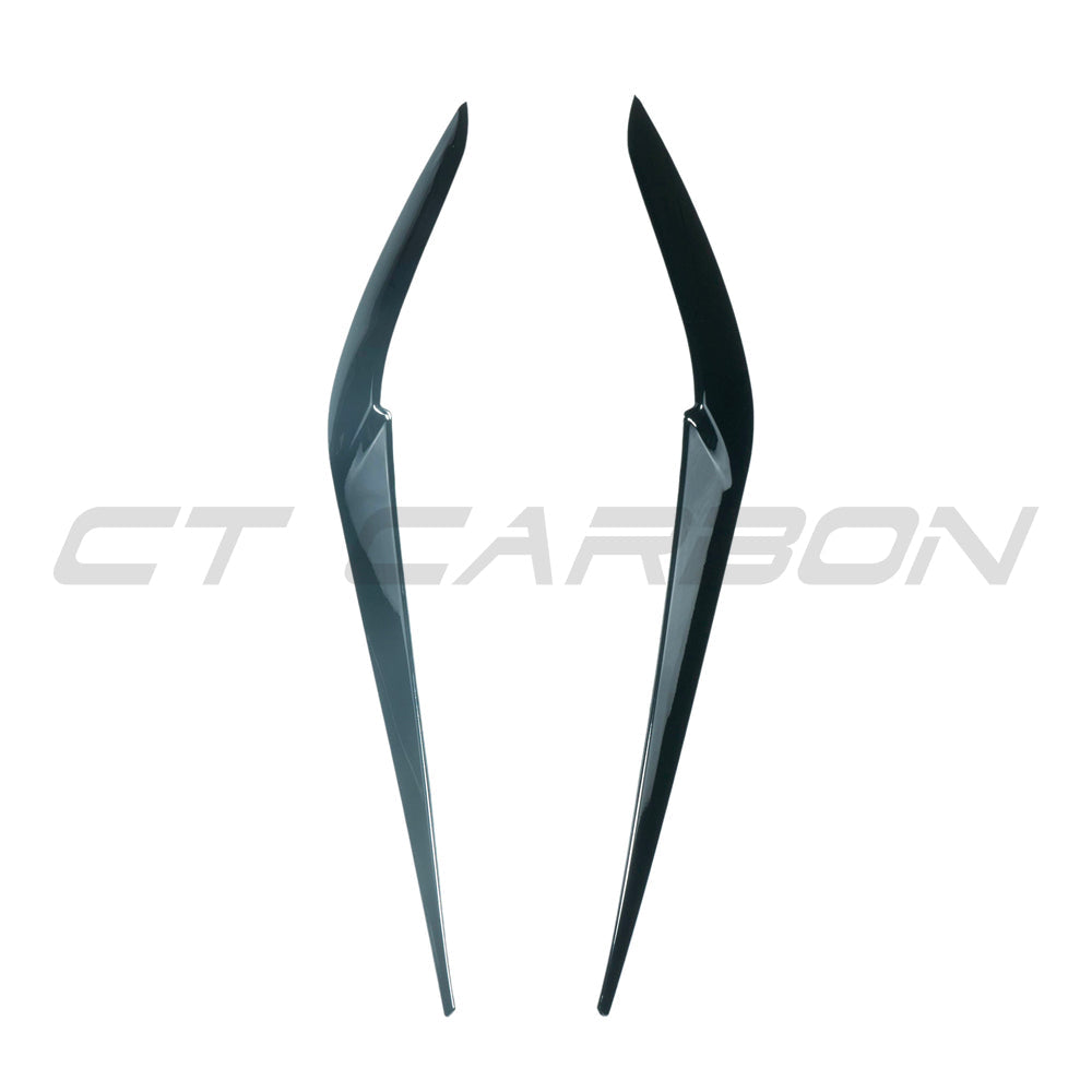 BMW X5 G05 and F95 X5M gloss black headlight eyebrows by CT Carbon, close-up of sleek, aerodynamic automotive accessories.