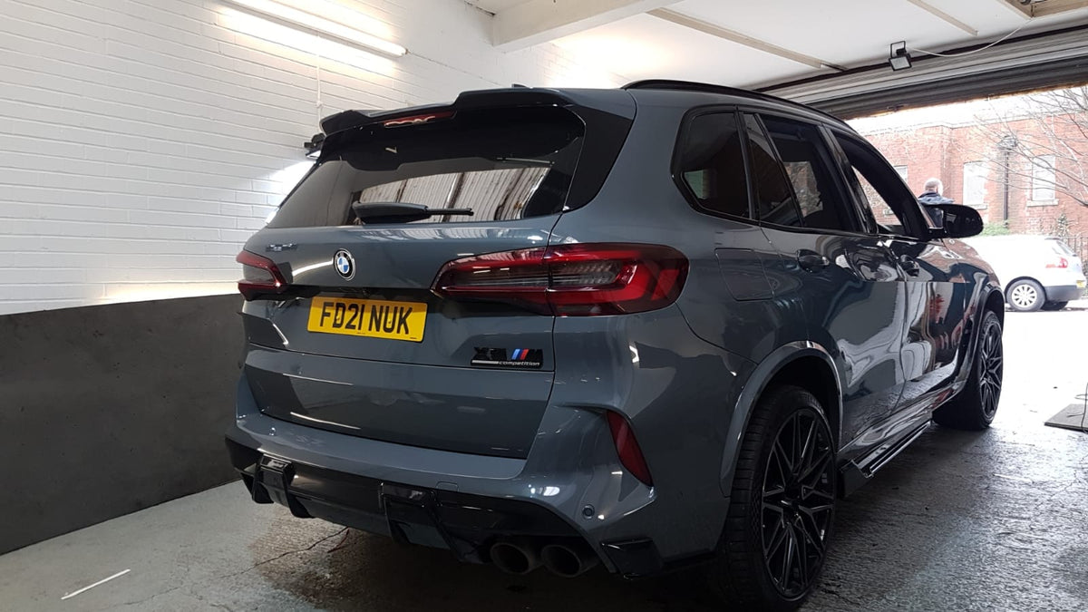 BMW X5M F95 2019-2022 pre-LCI gloss black kit by CT Carbon, featuring sleek exterior enhancements on the vehicle.