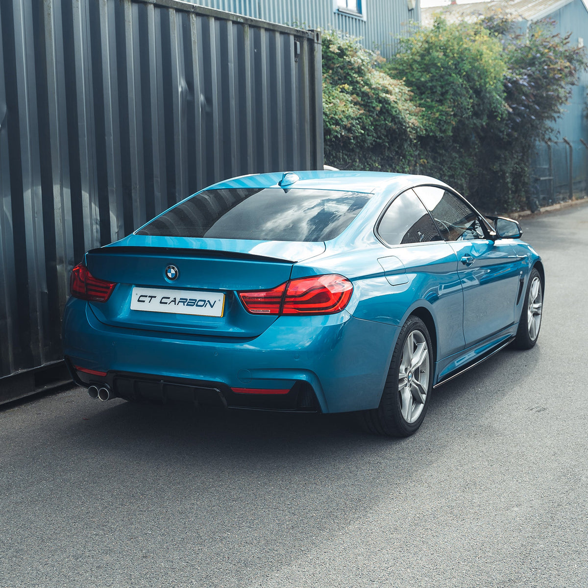 BMW 4 Series F32 2013-2020 gloss black full kit with twin exhaust by CT Carbon, featuring sleek aerodynamic design.