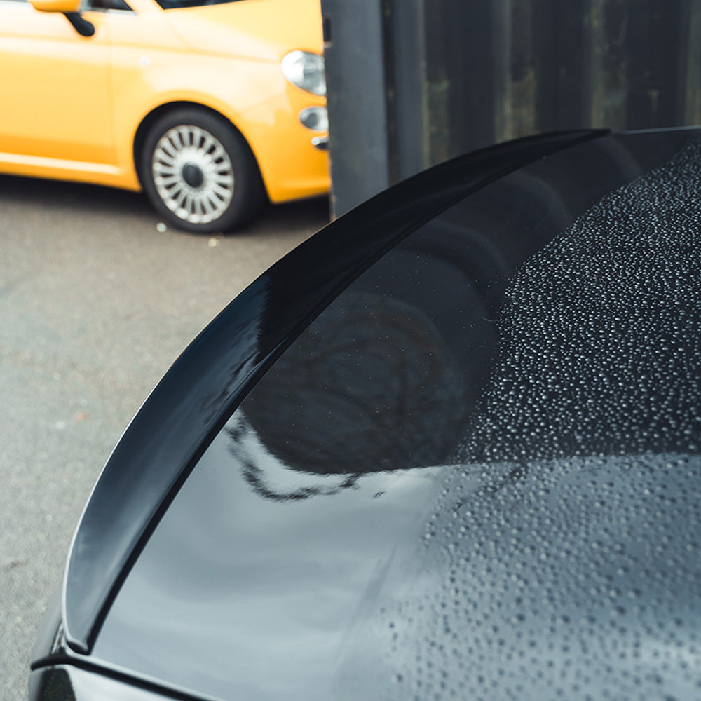 BMW 5 Series G30 gloss black spoiler by CT Carbon, showing the sleek, aerodynamic design mounted on the rear of the vehicle.