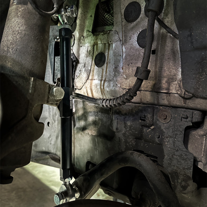 BMW E90/E92 M3 Suspension Secrets adjustable front drop links installed on suspension linkage system.