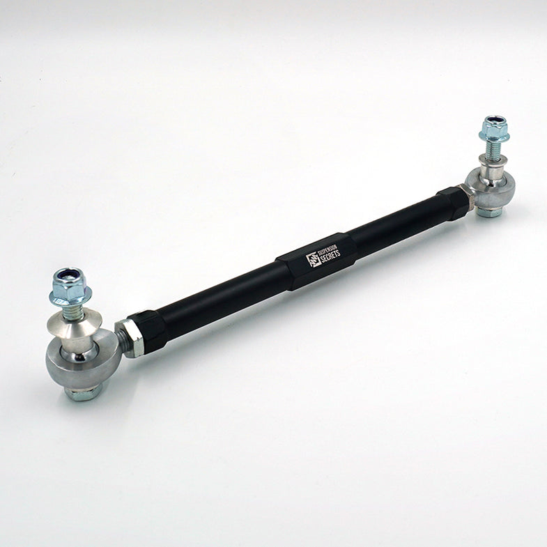 Suspension Secrets adjustable front drop links for BMW G87 M2, showing close-up of metal linkage with mounting points.