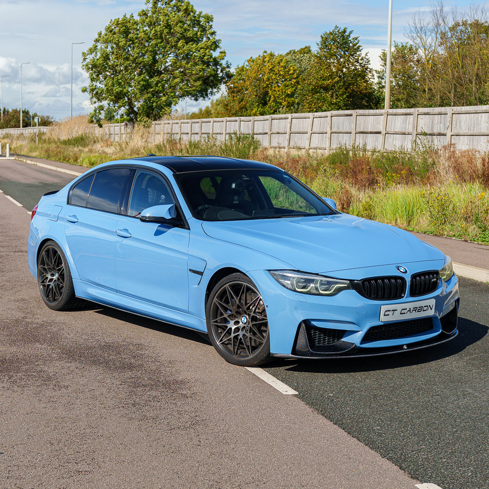 Blue BMW M3 F80 with CT Carbon full carbon fiber kit, showcasing a sleek exterior upgrade and aerodynamic enhancements.