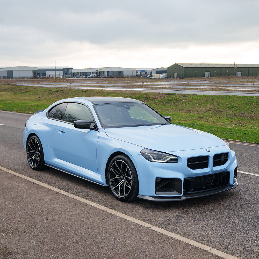 BMW G87 M2 2023 carbon fibre splitter by CT Carbon, V5 model, lightweight and aerodynamic, mounted on front of sports car.