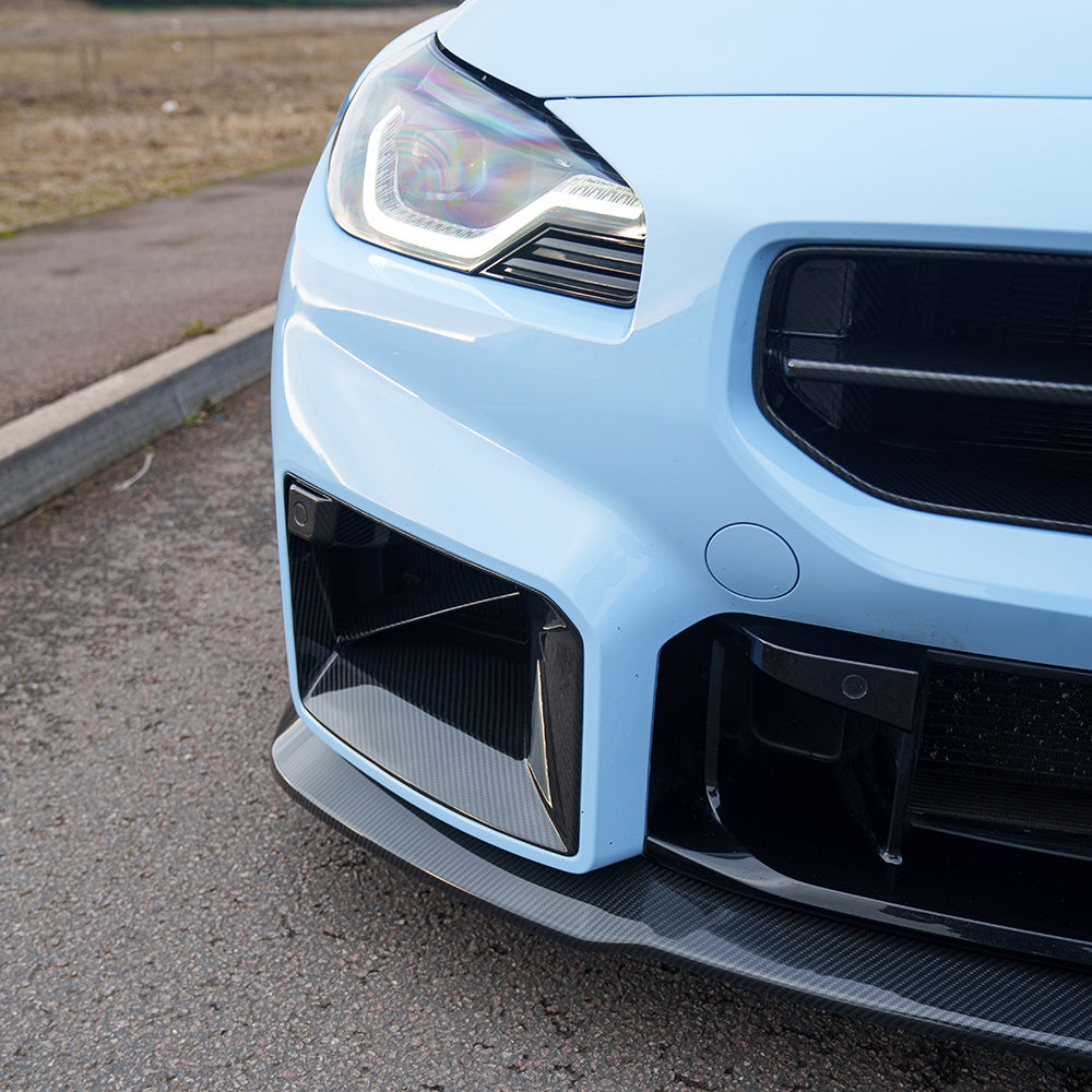 BMW G87 M2 2023 carbon fibre splitter by CT Carbon, V5 design, mounted on front of sporty performance car.