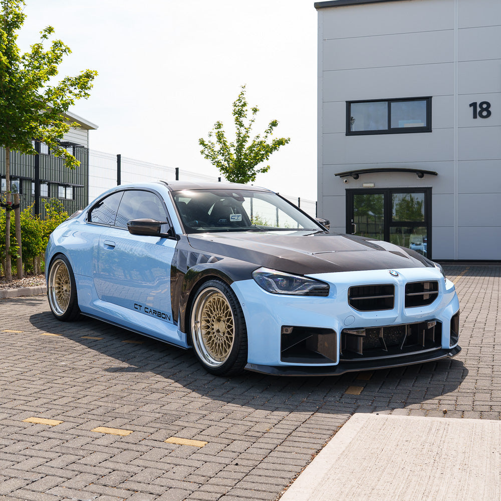 BMW G87 M2 CT Design carbon fiber kit, full car exterior components in glossy black carbon fiber, detailed close-up view.