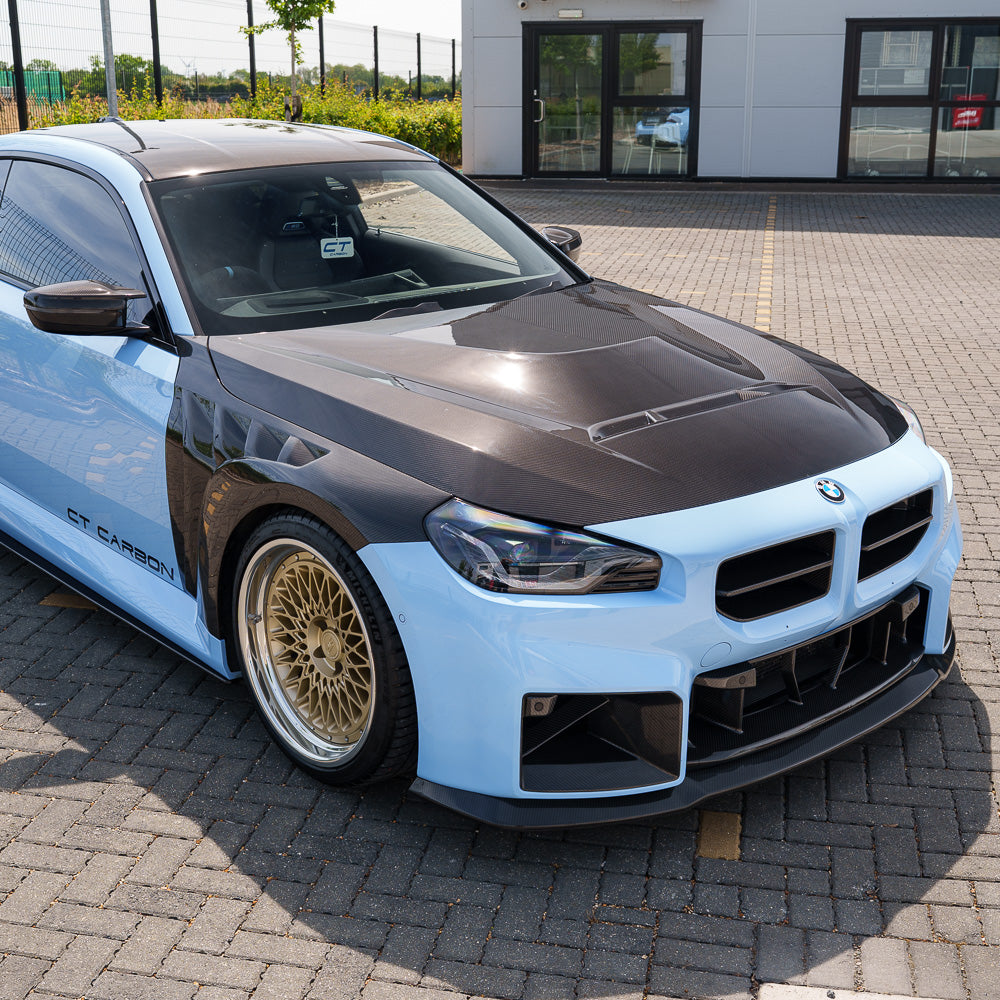 BMW G87 M2 CT Design full carbon fiber kit, featuring sleek carbon fiber panels and accents on the sporty car.