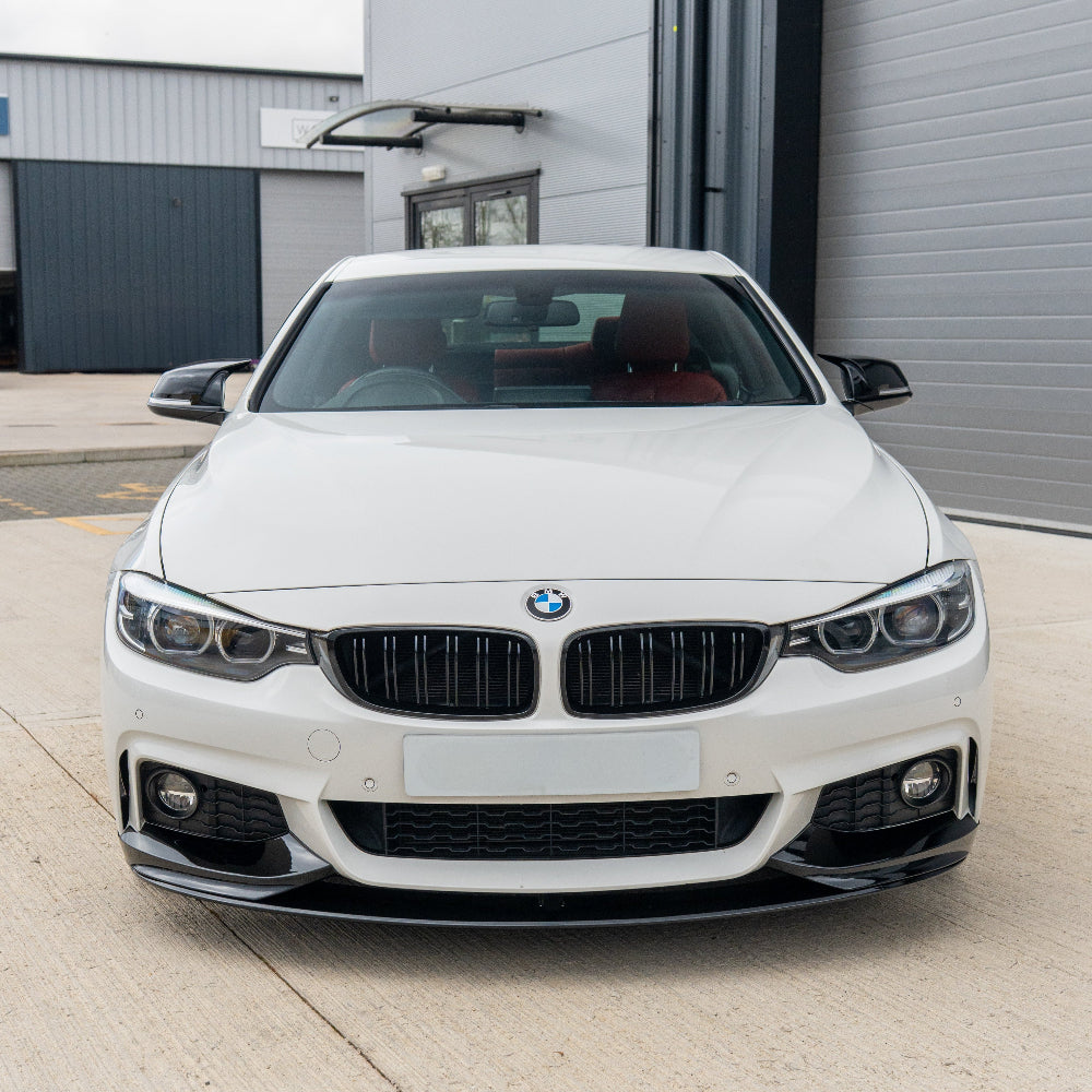 BMW Fxx Series gloss black mirrors by CT Carbon, close-up of sleek side mirror with reflective surface and aerodynamic design.