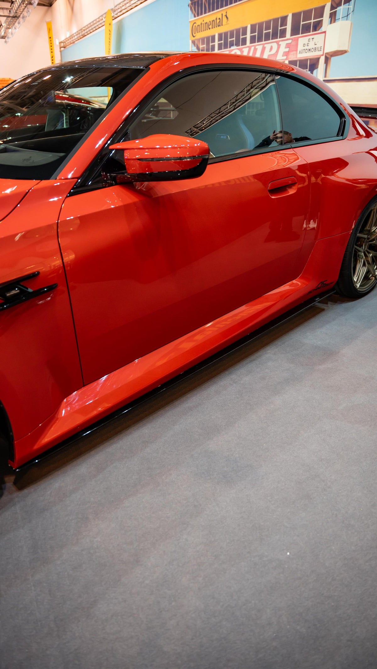 AC Schnitzer BMW M2 G87 side skirts, sleek aerodynamic exterior enhancement, shown in black with detailed design features.