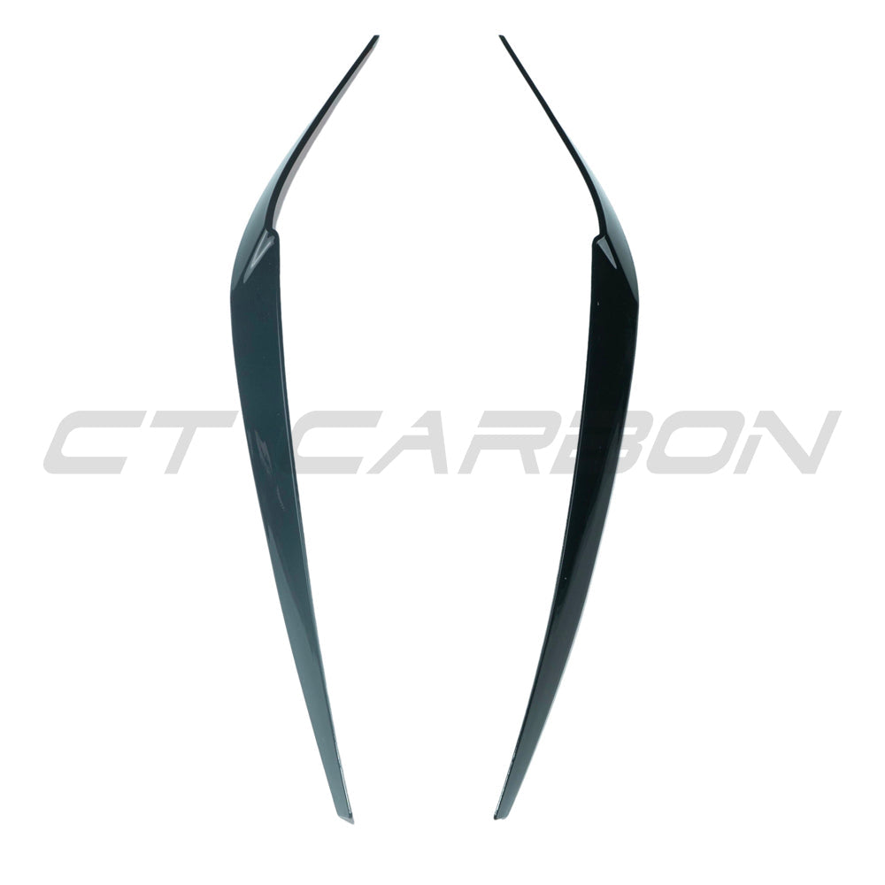 Black headlight eyebrows for BMW 5 Series G30 by CT Carbon, glossy black accessories enhancing front headlight appearance.