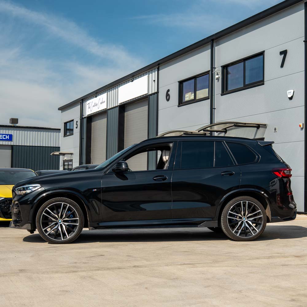 BMW G05 X5 full carbon fibre kit by CT Carbon, showing components and detailed carbon fibre finish on the car parts.
