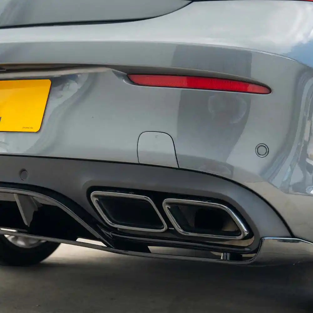Mercedes C-Class Coupe W205 diffuser with gloss black finish and black tips, designed by CT Carbon, shown in a close-up view.
