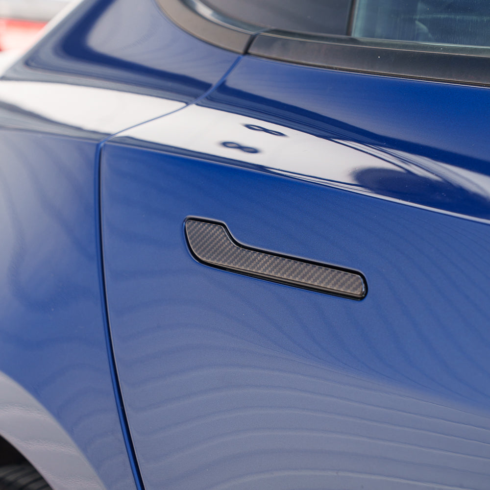Tesla Model 3 and Y 2017+ carbon fiber handle covers by CT Carbon, close-up of sleek, textured black accessory on car door handles.