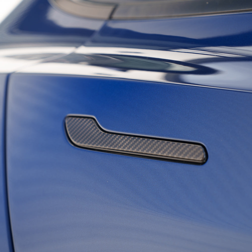 Tesla Model 3 and Y 2017+ carbon fiber handle covers by CT Carbon, showing sleek, textured carbon fiber surface on vehicle door handles.
