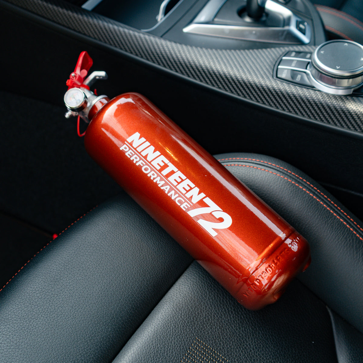 Race Safe BMW F8X footwell fire extinguisher kit with compact fire extinguishers mounted in the footwell area.