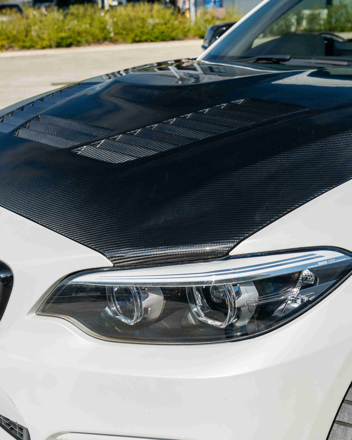 BMW M2 F87 and F20 F22 carbon fibre bonnet by CT Carbon, lightweight and sleek automotive hood with a textured finish.