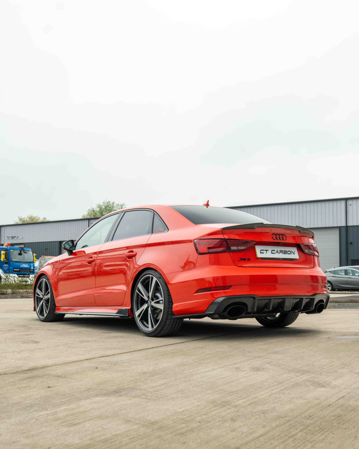 Carbon fibre side skirts for Audi A3/S3/RS3 8V saloon by CT Carbon, showing sleek, aerodynamic design on a white car.