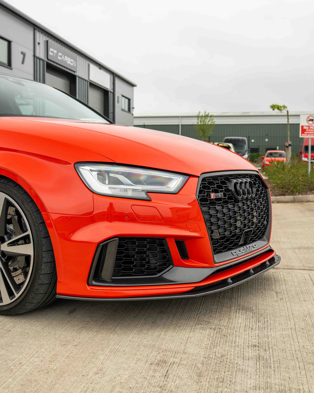 Audi RS3 8V facelift carbon fibre bumper trim by CT Carbon, close-up view of sleek, textured car accessory in black carbon fiber material.