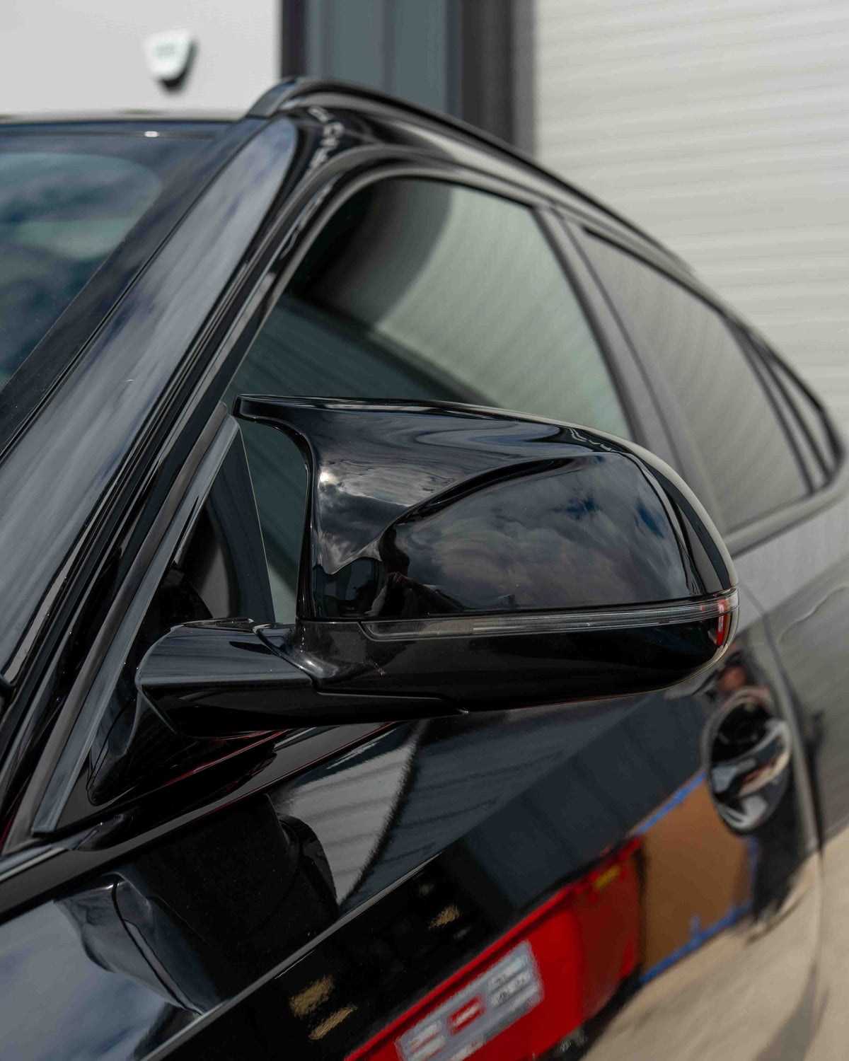 Gloss black carbon fiber side mirrors for BMW X3, X4, X5, X6 G01, G02, G05, G06 by CT Carbon, close-up of mirror housing.