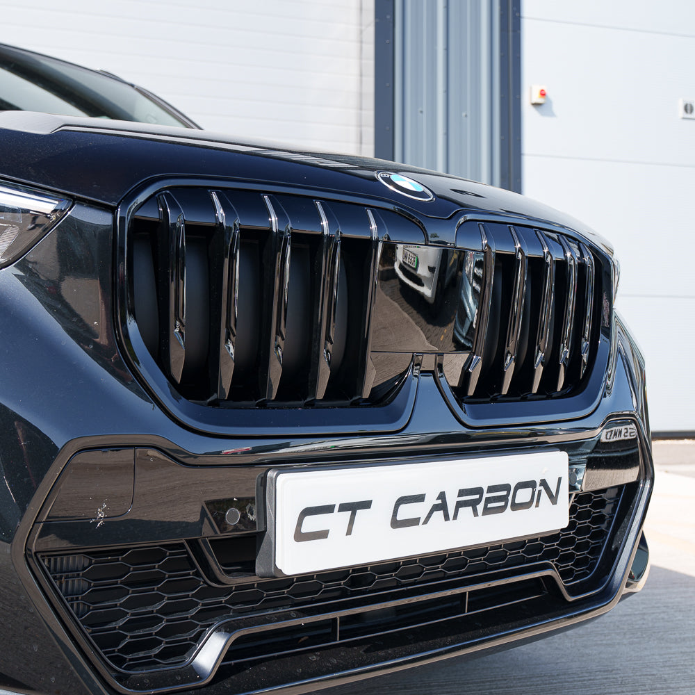 BMW U11 X1 2023 gloss black single slat grille by CT Carbon, showcasing the sleek, aerodynamic front grille design.
